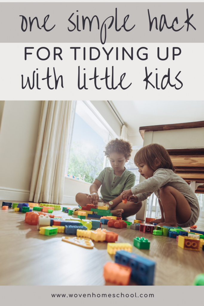 Two kids playing on the floor with the text "One simple hack for tidying up with young kids"